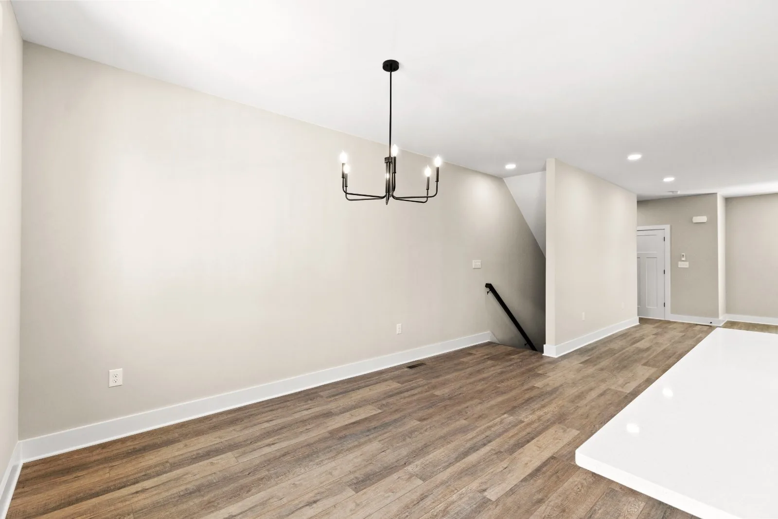 Dining area with chandelier and stairs