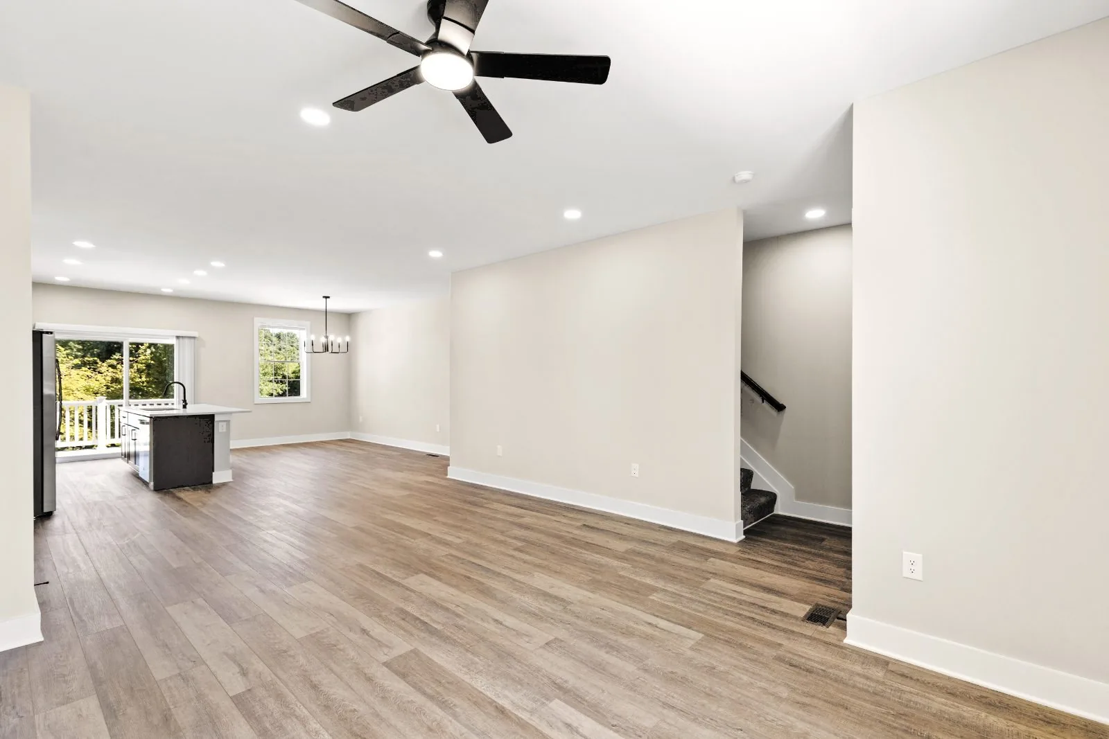 Open main level with kitchen island and stairs